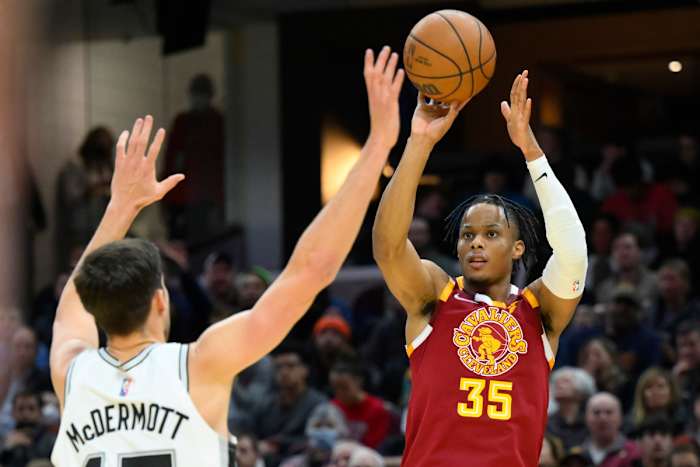 Feb 9, 2022; Cleveland, Ohio, USA; Cleveland Cavaliers forward Isaac Okoro (35) shoots beside San Antonio Spurs forward Doug McDermott (17) in the third quarter at Rocket Mortgage FieldHouse. Mandatory Credit: David Richard-USA TODAY Sports